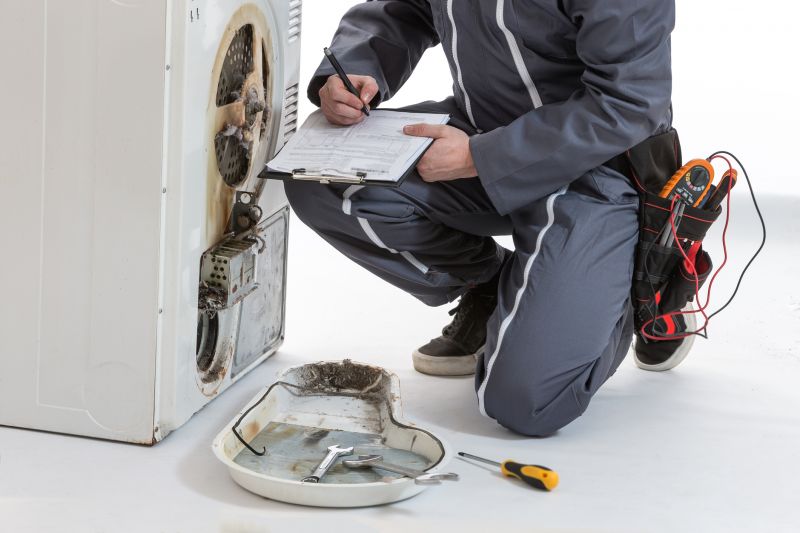 Dryer Repair Technician Inspecting Dryer